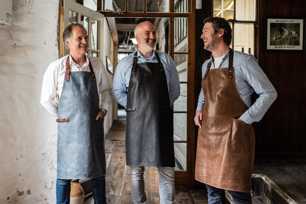 three people wearing an all leather handcrafted apron with removeable straps. made in britan