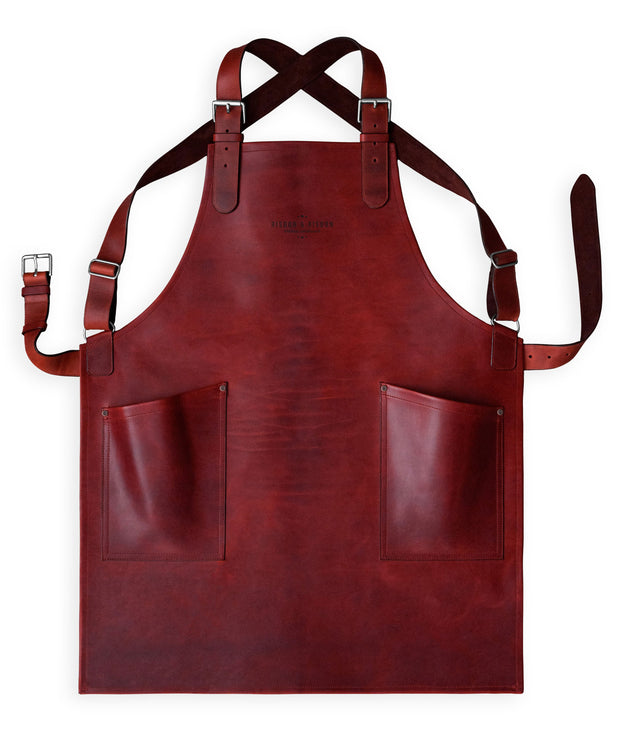 Handcrafted, fig red leather apron; made in Britain with matching pockets and straps.