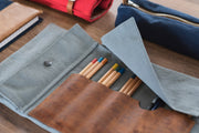 A handcrafted leather and canvas tool roll