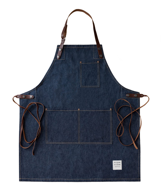 Handcrafted, heritage denim apron; made in Britain with pockets and removable leather straps.