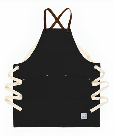 A handcrafted canvas apron with removable leather straps 