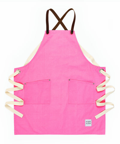 A handcrafted canvas apron with removable leather straps 