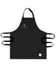 A black handcrafted canvas apron made in britan. features a brain and text saying the burnt chef collection in white